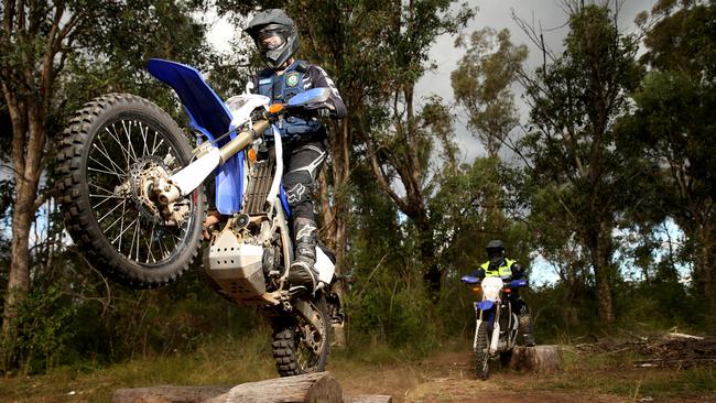 Mount Druitt Police trail bike squad officers Constable Andrew Klippert and Sergeant Dave Flood patrol near the Kevin Betts basketball stadium.