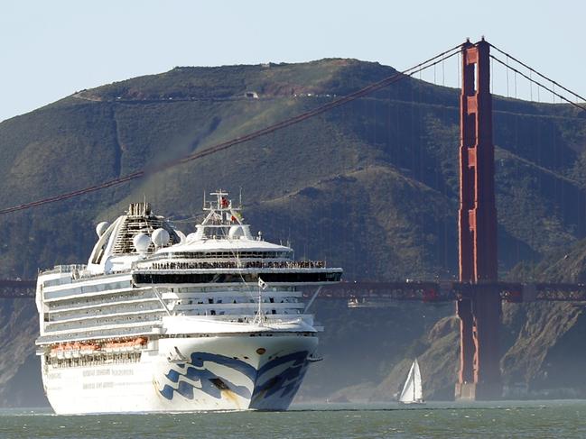 In this Feb. 11, 2020 photo, the Grand Princess cruise ship passes the Golden Gate Bridge as it arrives from Hawaii in San Francisco. California's first coronavirus fatality is an elderly patient who apparently contracted the illness on a cruise, authorities said Wednesday, March 4, and a medical screener at Los Angeles International Airport is one of six new confirmed cases. The cruise ship is at sea but is expected to skip its next port and return to San Francisco by Thursday, according to a statement from Dr. Grant Tarling, the chief medical officer for the Carnival Corp., which operates the Grand Princess. Any current passengers who were also on the February trip will be screened. (Scott Strazzante/San Francisco Chronicle via AP)