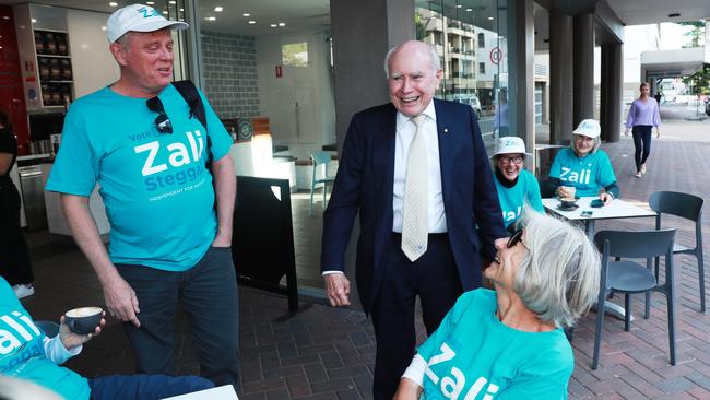 Mr Howard chats with supporters of Ms Deves’ rival, independent MP Zali Steggall. Picture: John Feder