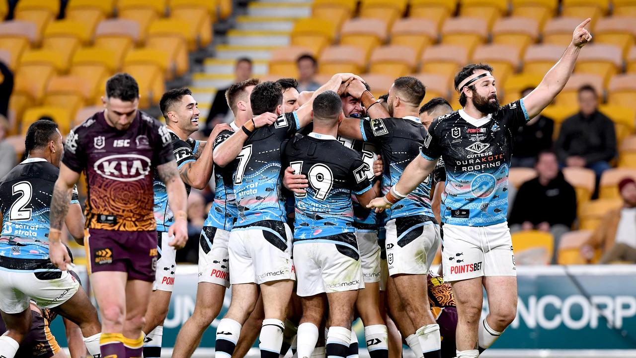 BRISBANE, AUSTRALIA - JULY 31: Braden Hamlin-Uele of the Sharks is congratulated by team mates after scoring a try during the round 12 NRL match between the Brisbane Broncos and the Cronulla Sharks on July 31, 2020 in Brisbane, Australia. (Photo by Bradley Kanaris/Getty Images)