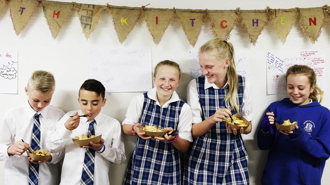 Yum: Zac Williams, Hutch Purdue, Anna Butler, Grace Burke and Mily Rogers tuck in. Picture: Braden Fastier