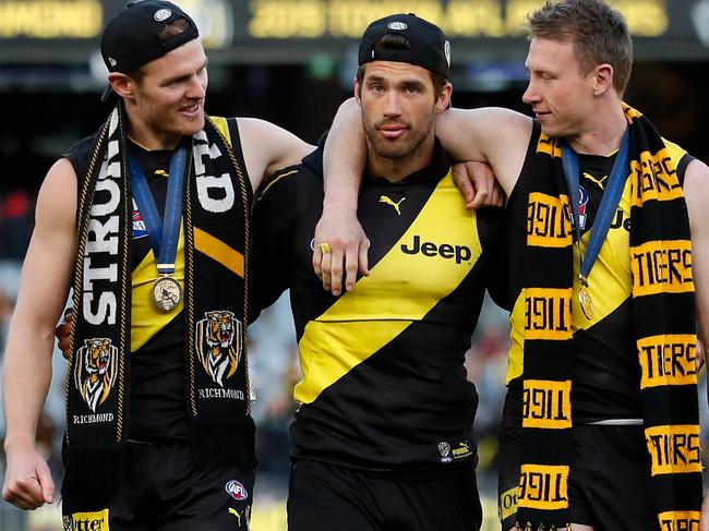 MELBOURNE, AUSTRALIA - SEPTEMBER 28: David Astbury, Alex Rance and Dylan Grimes of the Tigers celebrate during the 2019 Toyota AFL Grand Final match between the Richmond Tigers and the GWS Giants at the Melbourne Cricket Ground on September 28, 2019 in Melbourne, Australia. (Photo by Michael Willson/AFL Photos via Getty Images)