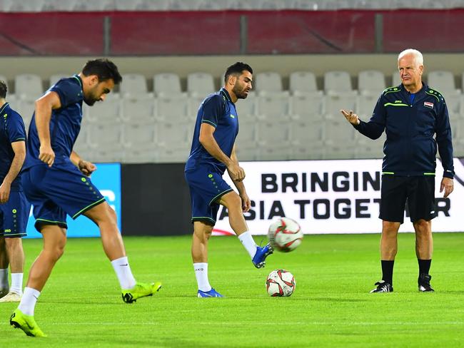 Syria's German coach Bernd Stange (1st-R) attends a training session with his players at Sharjah stadium in Sharjah on January 5, 2019, a day ahead of his team's match against Palestine in the 2019 AFC Asian Cup football tournament. (Photo by GIUSEPPE CACACE / AFP)