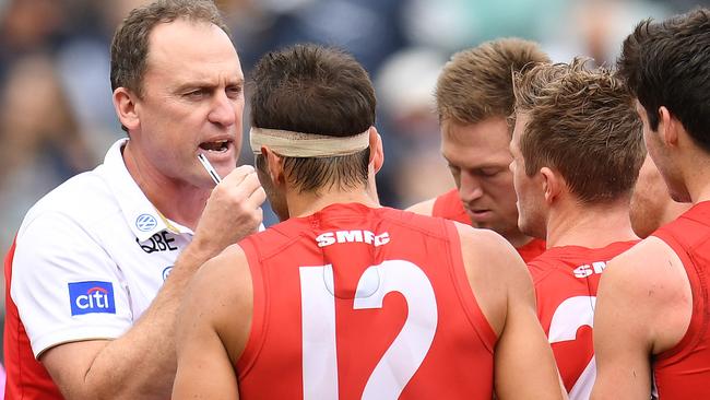 Sydney coach John Longmire talks to his players at the MCG.