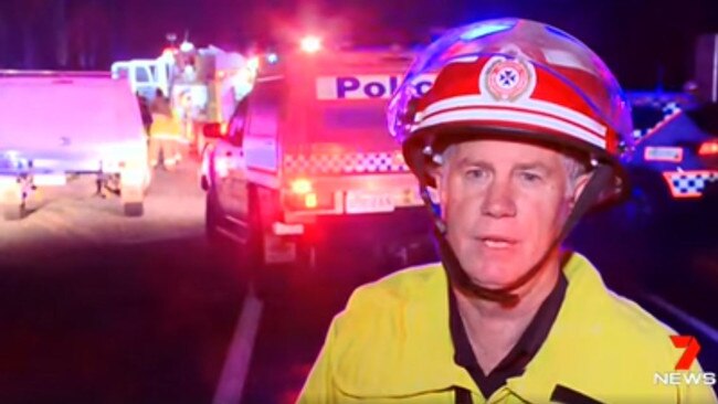 Emergency service workers at the scene of Saturday's double fatality on the Bruce Highway at Kolonga.