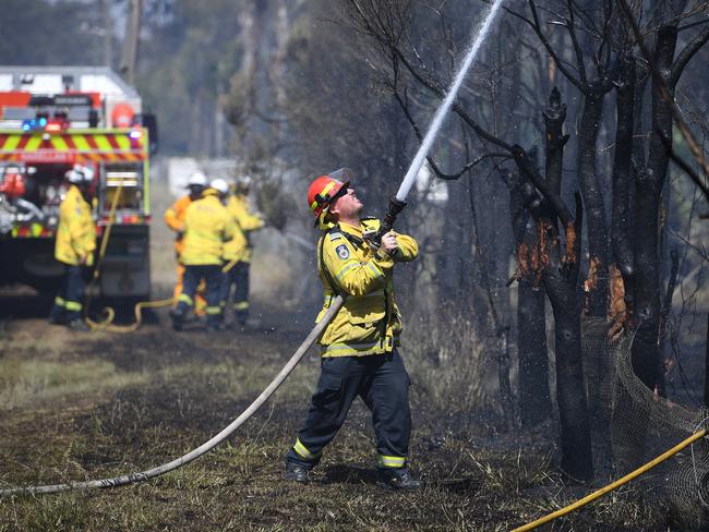 Crew mop up after a grass fire impacted a property on Fourth Ave, Llandilo. Picture: Dan Himbrechts