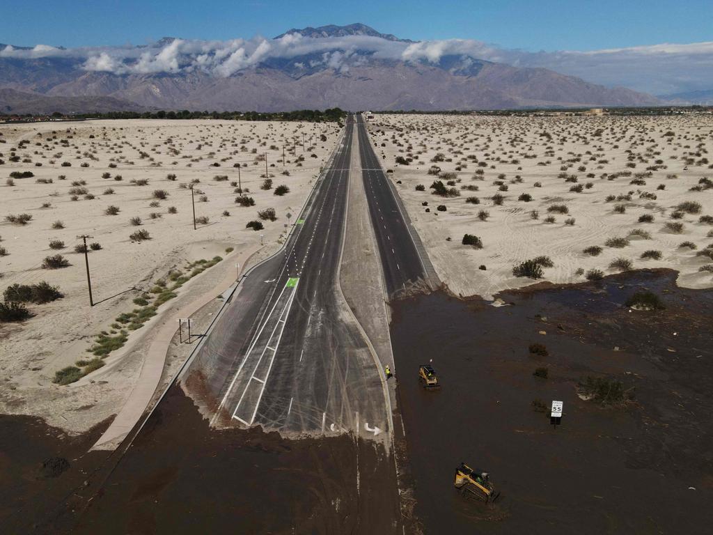 An aerial image shows no traffic on Interstate 10 due to flooding and mud crossing the highway following heavy rains from Tropical Storm Hilary, in Rancho Mirage, California, Picture: AFP