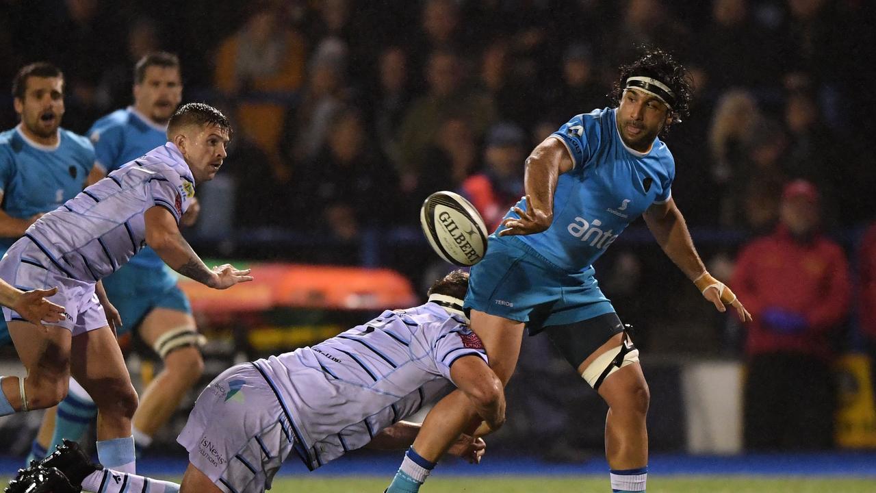 Diego Ormaechea of Uruguay passes as he is tackled by James Down of Cardiff Blues.