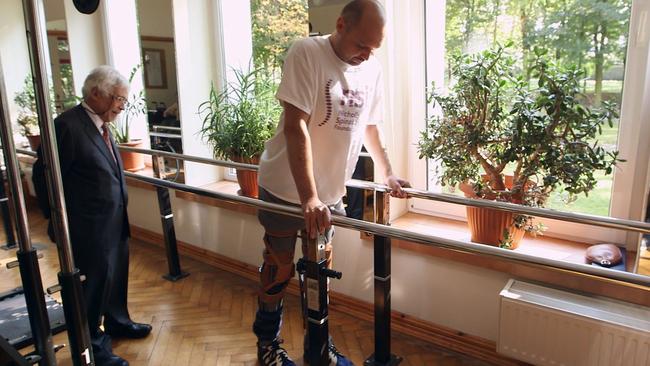 Darek Fidyka walking with the assistance of parallel bars and leg braces at the Akron Neuro-Rehabilitation Centre in Poland. Picture BBC