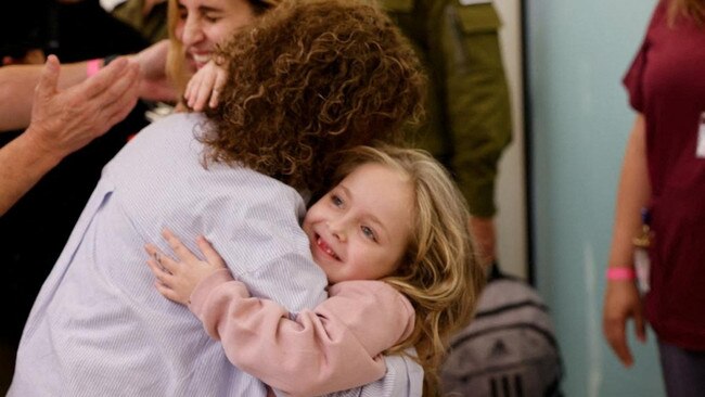 Six year-old Amelia Aloni hugs a woman as she and her mother Danielle meet their family members after their return, during a temporary truce between Hamas and Israel. Picture: Reuters/Supplied