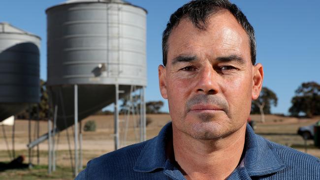 President of the Western Australian Farmers Federation and mixed grains farmer Rhys Turton poses for a photograph next to his barley seed silos near York in the Wheatbelt region, 100km east of Perth on Tuesday, May 19, 2020. China today imposed an 80% tariff on barley imports from Australia. Barley usually makes up about 30% of his total crop but he will now be substituting most of his barley for other grains. (AAP Image/Richard Wainwright) NO ARCHIVING