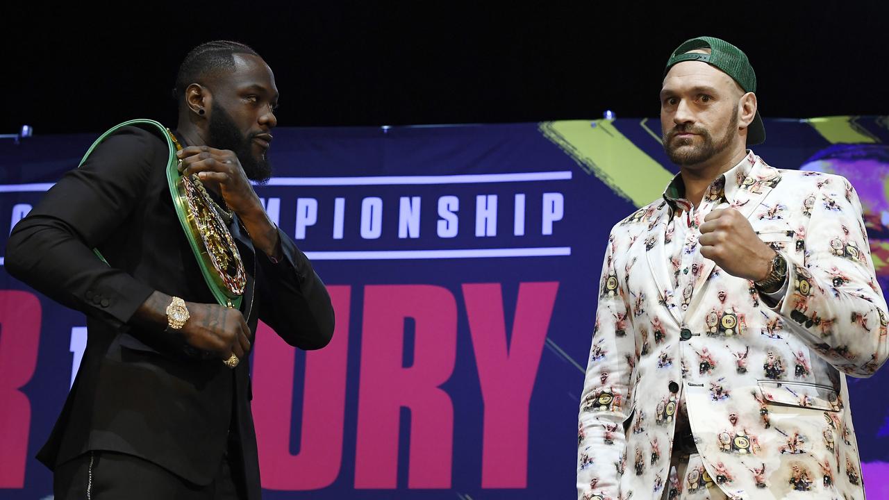 Deontay Wilder (L) and Tyson Fury get together during a news conference.