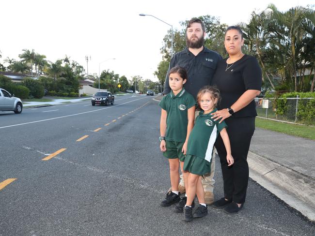 Andrew Hall and Suzanne Hall with their children Georgia, 5, and Chloe, 8, at 'kiss and go' zone outside Helensvale State School. Picture: Glenn Hampson.