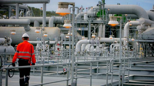 A worker walks through a plant at the Curtis Island Liquefied Natural Gas project site. Shell QGC has announced between 7000 and 9000 jobs worldwide will be cut due to a global restructure, including an unknown number from its about 1200 strong Gladstone and Queensland workforce.