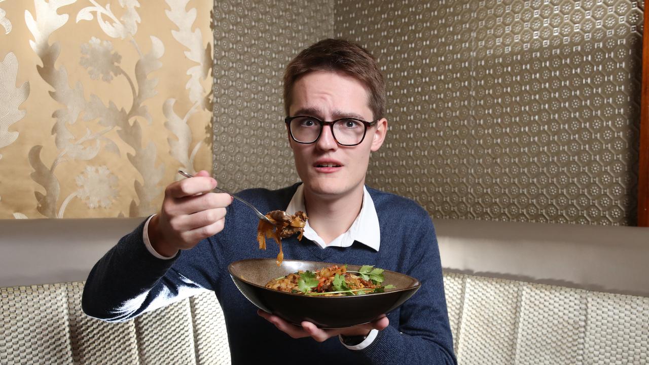 Courier Mail journalist Matthew Johnston eats Queensland's spiciest noodle dish at Fat Noodle restaurant at Treasury Casino. Picture: Zak Simmonds