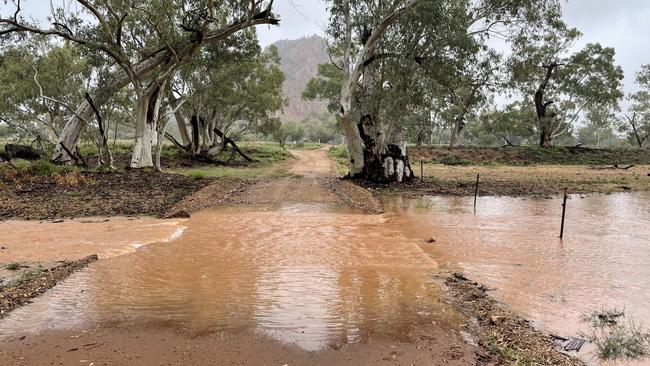 Roe Creek in Ilparpa flows over a floodway following steady rain in Central Australia