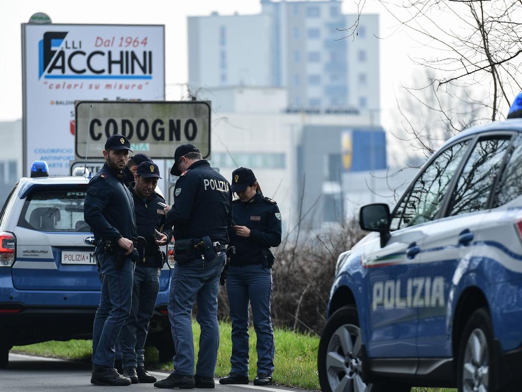 Italian National Police officers patrol at the entrance of the small Italian town of Codogno. Picture: Miguel Medina/AFP