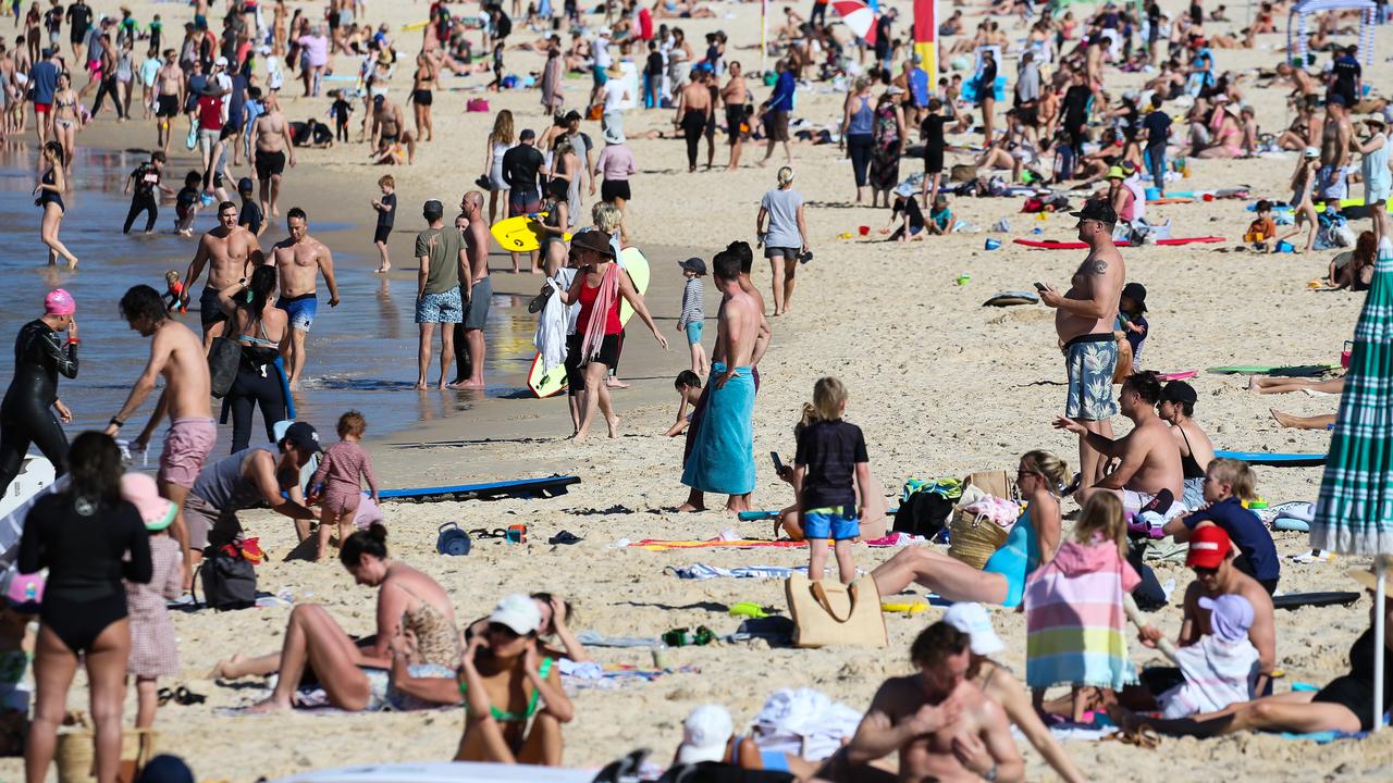 People are seen out enjoying the hot weather in Bondi Beach as lockdown continues in Sydney: NCA NewsWire / Gaye Gerard