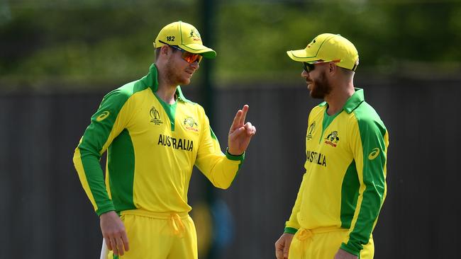 Steve Smith and David Warner chat during their World Cup warm-up clash against West Indies Picture: Getty