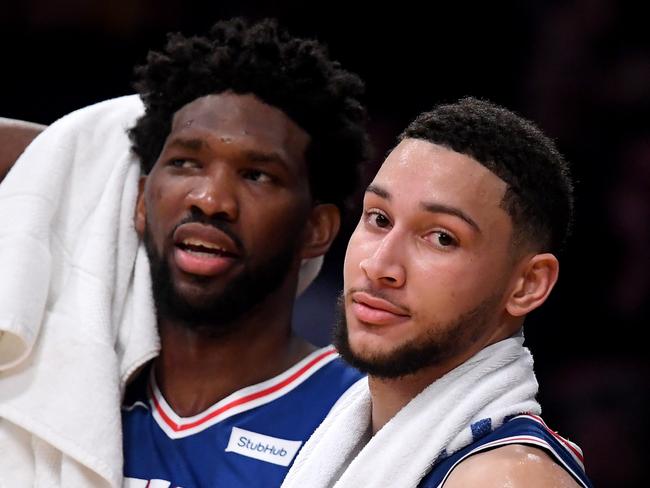 LOS ANGELES, CALIFORNIA - JANUARY 29: Ben Simmons #25 and Joel Embiid #21 of the Philadelphia 76ers watch play in the final minutes during a 121-105 win over the Los Angeles Lakers at Staples Center on January 29, 2019 in Los Angeles, California. NOTE TO USER: User expressly acknowledges and agrees that, by downloading and or using this photograph, User is consenting to the terms and conditions of the Getty Images License Agreement.   Harry How/Getty Images/AFP == FOR NEWSPAPERS, INTERNET, TELCOS & TELEVISION USE ONLY ==