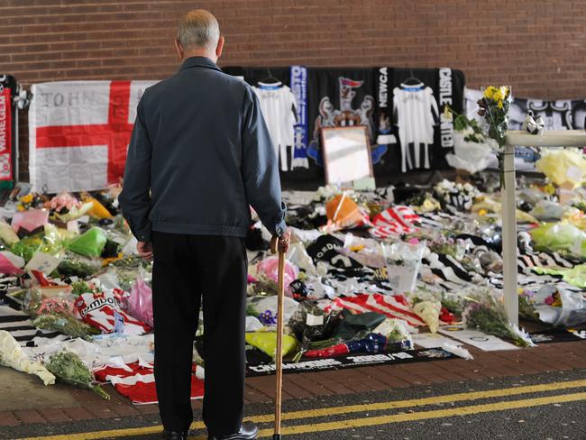 A man looks on at flowers and tributes that were left at St James’s Park, home of Newcastle United Football Club in honour of John Alder and Liam Sweeney on July 22, 2014 in Newcastle upon Tyne, England. The two lifelong Newcastle fans died along with 296 others in the Malaysian flight MH17 disaster in the Ukraine. Picture: Getty