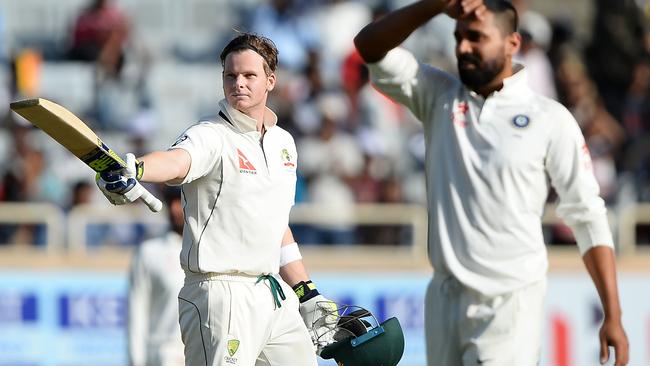 Australia's captain Steve Smith raises his bat while celebrating his century.