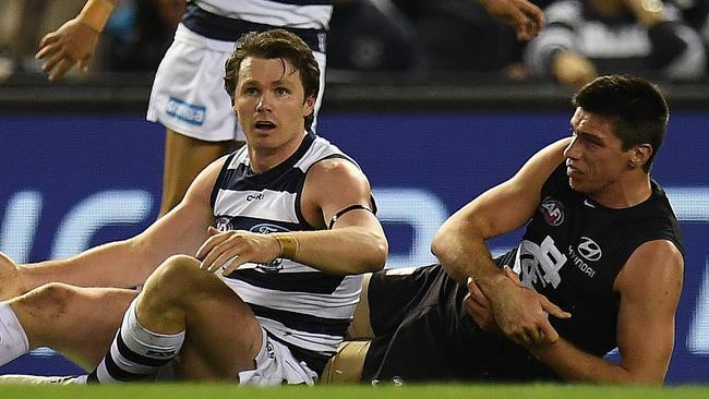 Patrick Dangerfield of the Cats (front left) and Matthew Kreuzer of the Blues (right) are seen after Dangerfield executed a tackled on the ruckman during the Round 19 AFL match between the Carlton Blues and the Geelong Cats at Etihad Stadium in Melbourne, Saturday, July 29, 2017. (AAP Image/Julian Smith) NO ARCHIVING, EDITORIAL USE ONLY