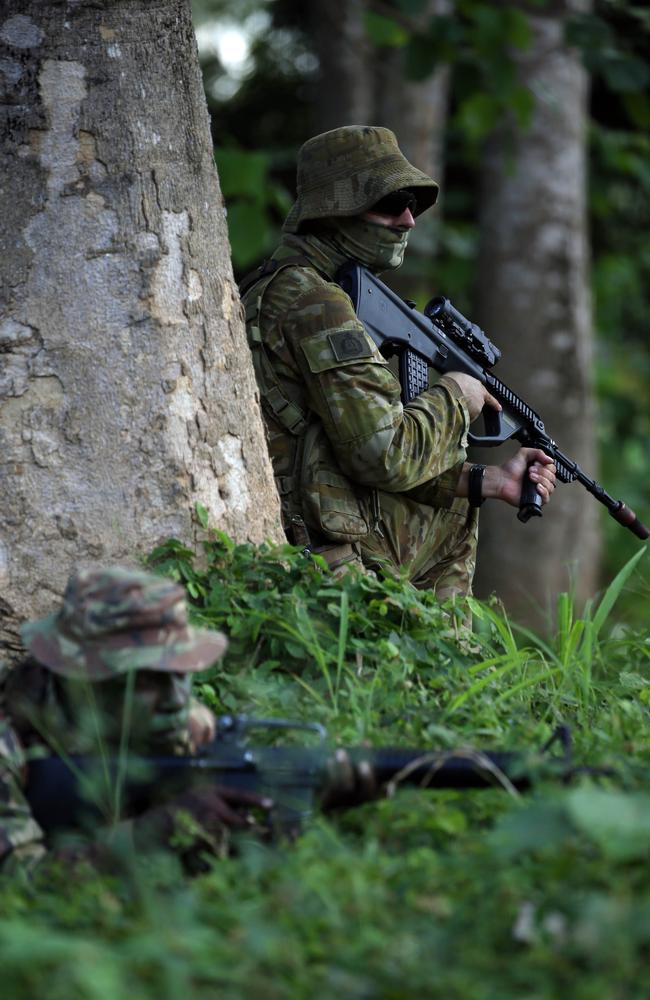 Aussie diggers with PNG soldiers during an exercise in jungle warfare. Picture Gary Ramage