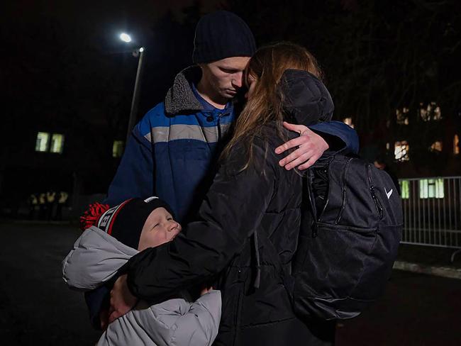 A man hugs his family after his release. Picture: AFP