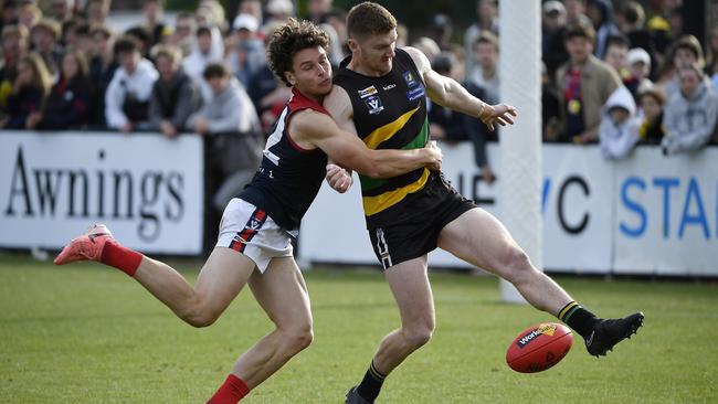 Mt Eliza player Lachlan Williams tackles Dromana player Ryan Morrison. Picture: Andrew Batsch