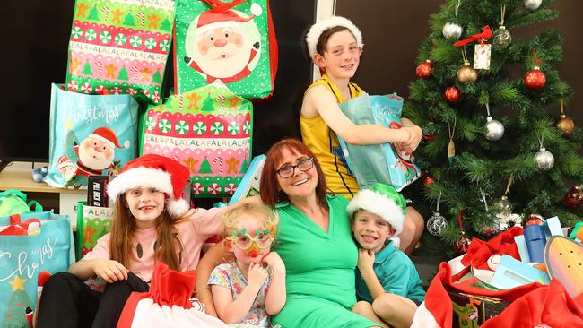 St Albans Park grandmother Wendy Bourke who saves up all her overtime money throughout the year to buy presents for kids in foster care, pictured with grand children Ivy, 8, Miranda, 4, Alfie, 6 and Jasper, 10. Picture: Alison Wynd