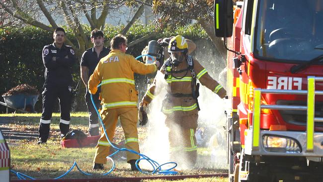 Fire fighters are hosed down after battling a shed fire at 262 Pigdon St, Portarlington. Picture: Alison Wynd
