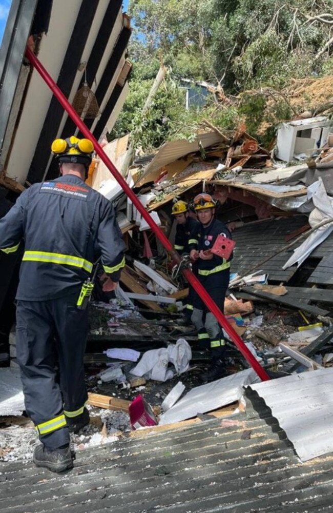 A rescue team used steel poles to hold up the roof while they saved a trapped woman in Orua Bay. Picture: Bay of Plenty Fire and Emergency