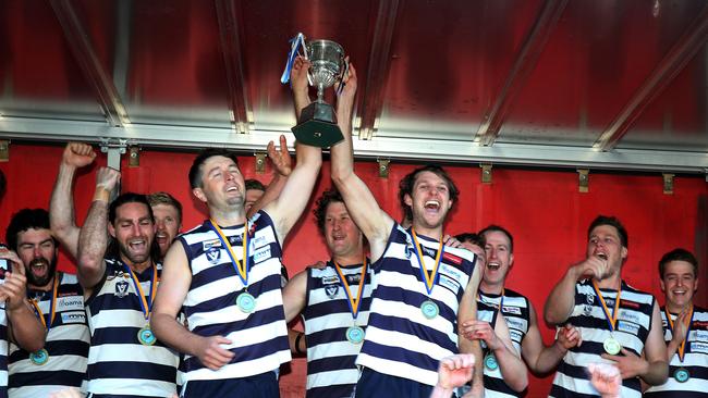 Lockington Bamawm United coach Brodie Collins and his players with the premiership cup after beating Mt Pleasant in the grand final. Picture Yuri Kouzmin