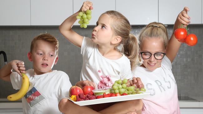 The Callinan kids, Paddy, 9, Maggie, 5, and Emily 11, eating healthy afternoon snacks. Picture: Alex Coppel.