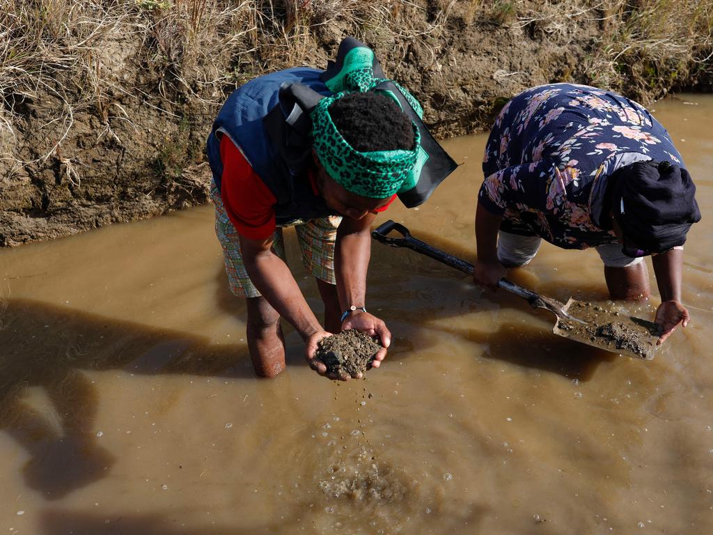 People pan for diamonds at the site. Picture: Phill Magakoe/AFP