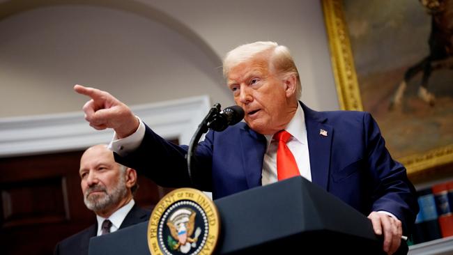 US President Donald Trump, accompanied by Commerce Secretary Howard Lutnick, takes a question from a reporter in the Roosevelt Room of the White House. Picture: Andrew Harnik/Getty Images