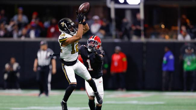 Chris Olave goes up for the ball. Todd Kirkland/Getty Images/AFP