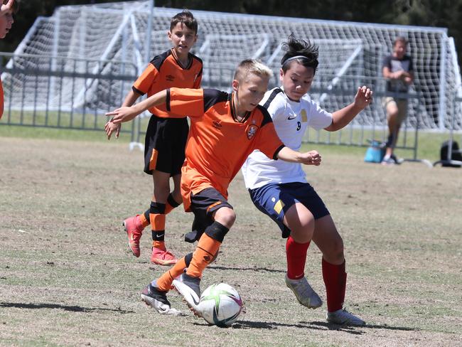 The Premier Invitational football tournament on the Gold Coast. Brisbane Roar Orange v TFC Brisbane White under-13s in action. Picture: Mike Batterham.