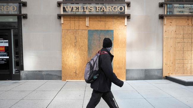 A man walks past a boarded up Wells Fargo bank, in Washington. Picture: Andrew Cballero-Reynolds/AFP