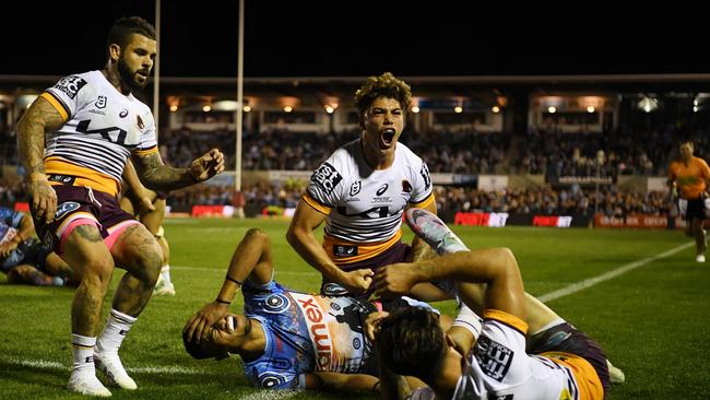 Flexing their title muscle: Broncos defenders stop Sharks winger Ronaldo Mulitalo from scoring. Picture: NRL Photos