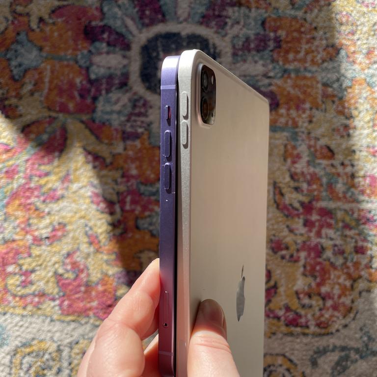 On the left is a purple iPhone 12 and the thinner iPad Pro is on the right. Picture: Elly Awesome