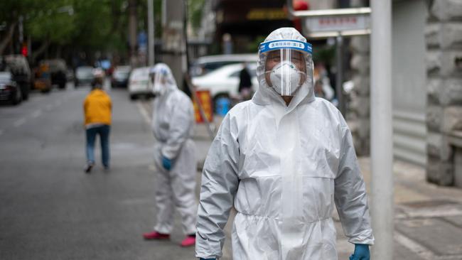 A man wearing a hazmat suit walks along a street in Wuhan. Picture: AFP