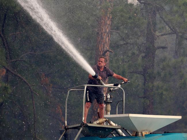 Steve Rhind uses his tanker to help fight the fires. Picture: Nathan Edwards