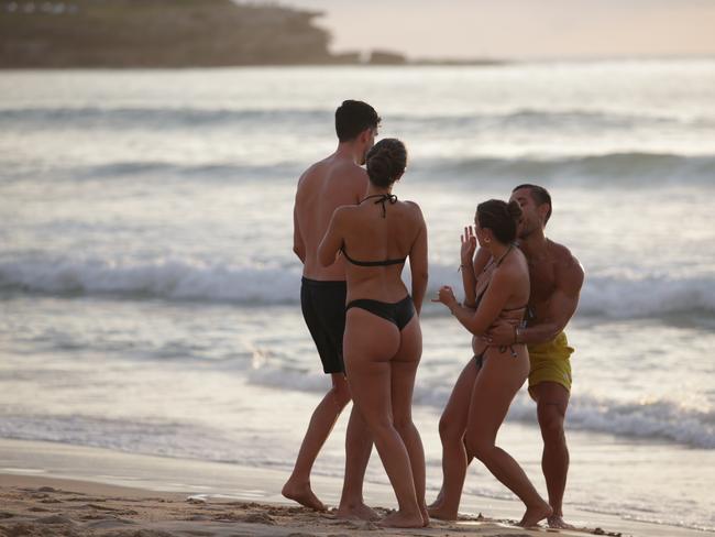 SYDNEY, AUSTRALIA - NewsWire Photos - 01 JANUARY, 2025:Early morning sunrise coverage from Sydney's iconic Bondi Beach as the first day of 2025 rings in with revellers from New Years Eve still enjoying festivities as dawn breaks.Picture: NewsWire / Christian Gilles