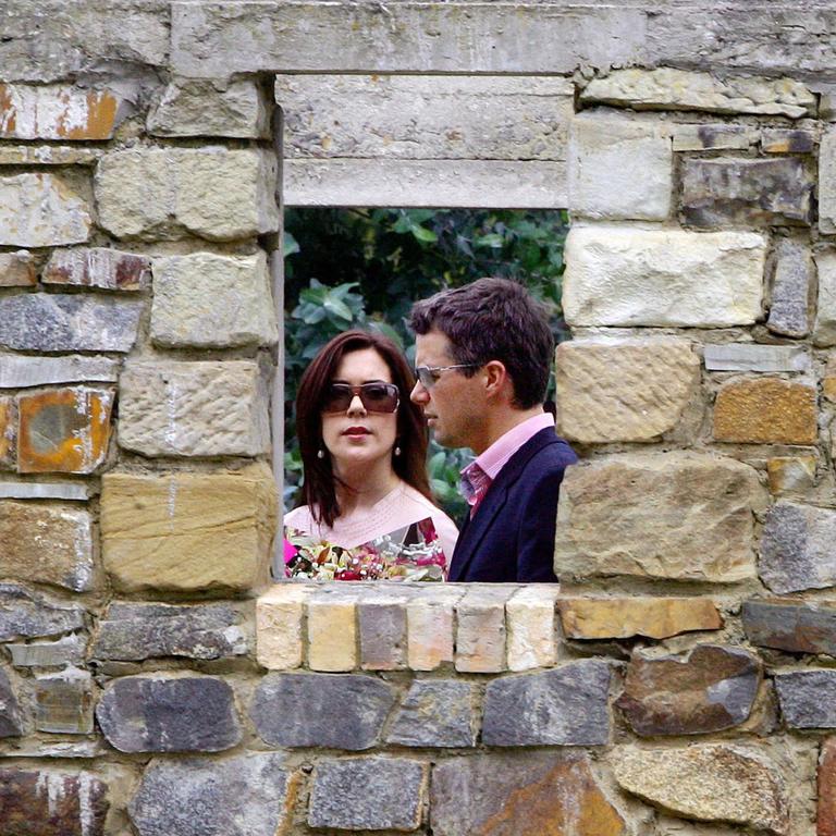 The couple walk during a visit to the ruins of the Broad Arrow Cafe in Port Arthur. Picture: David Gray/AP