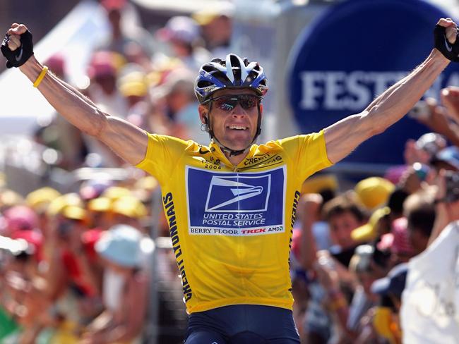 LE GRAND BORNAND, FRANCE - JULY 22:  Lance Armstrong of the USA and riding for US Postal Service presented by Berry Floor celebrates as he wins stage 17 of the Tour de France on July 22, 2004 from Bourg d'Oisans to le Grand Bornand, France. (Photo by Doug Pensinger/Getty Images)