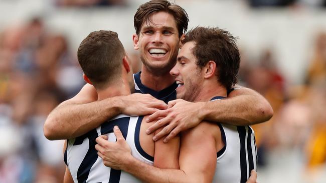 Sam Menegola, Tom Hawkins and Daniel Menzel celebrate Geelong’s win over Hawthorn. Picture: Getty Images