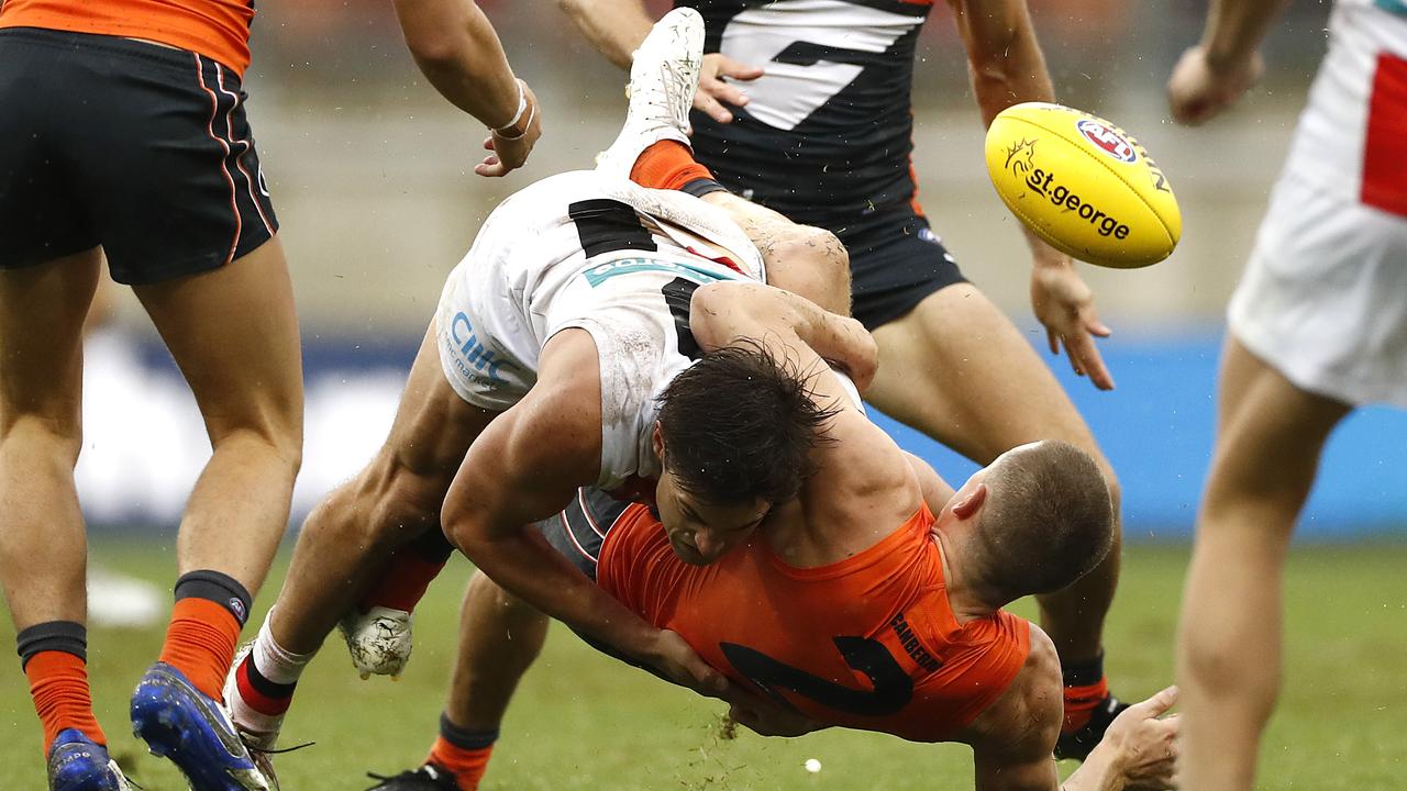 Jack Steele of the Saints tackles Jacob Hopper of the Giants.