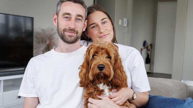 Rory Esler who received a shock diagnosis of  Advanced Stage 3 metastatic bowel cancer, at home in New Farm with partner Olivia and dog George. Picture Lachie Millard